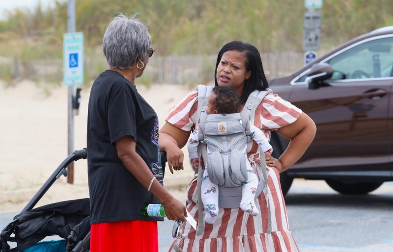The Rev. Deborah McCaffity, left, talks with Rep. Alonna Berry, D-Milton, at Johnnie Walker Beach Day.
